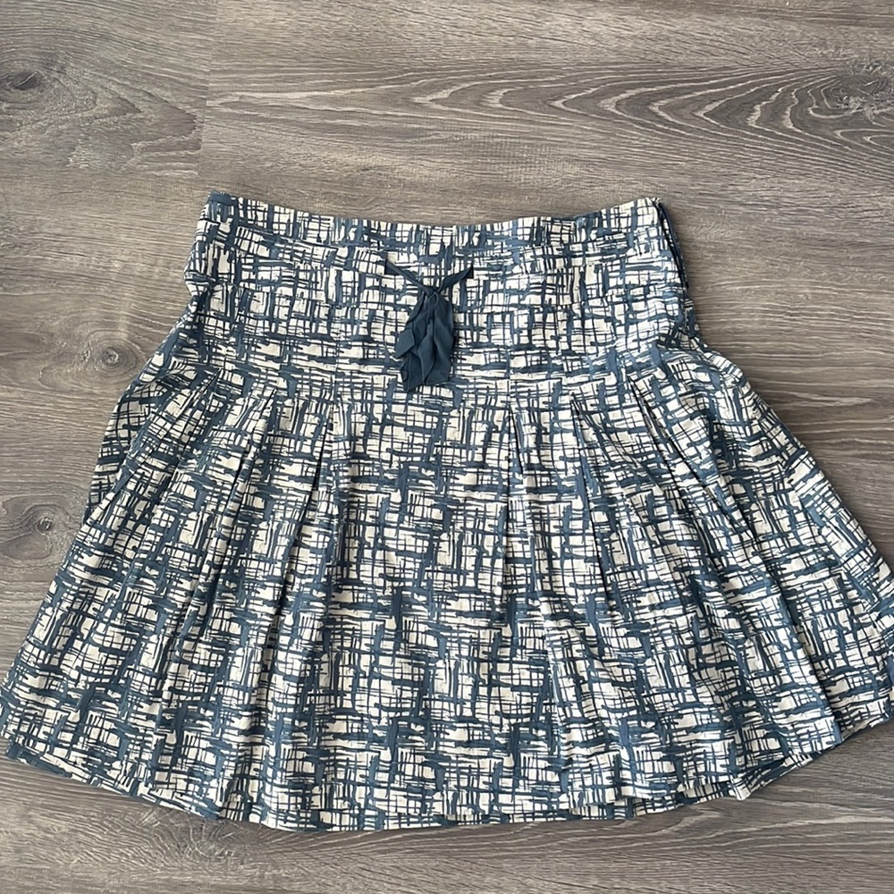 Flowing skirt with delicate ribbon detail.